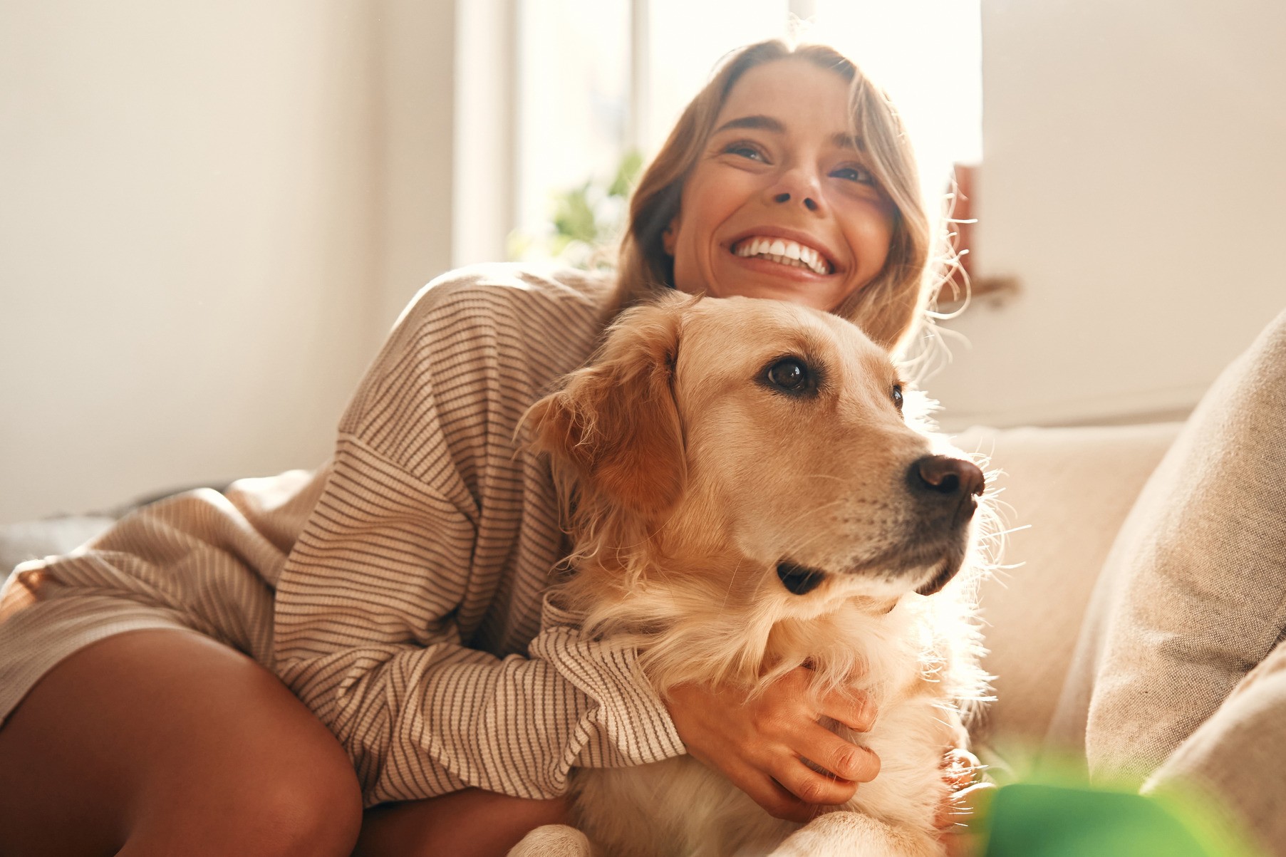 Woman holding her healthy dog after heartworm prevention with Dr. Hazard
